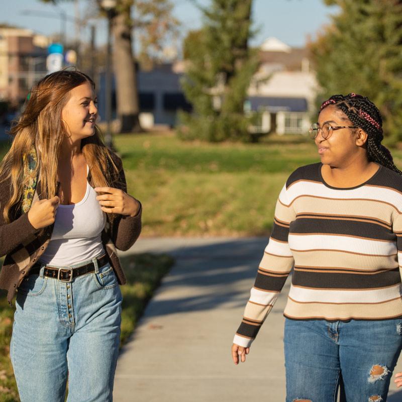 Two individual students feeling accepted and supported in their emotional well-being on campus